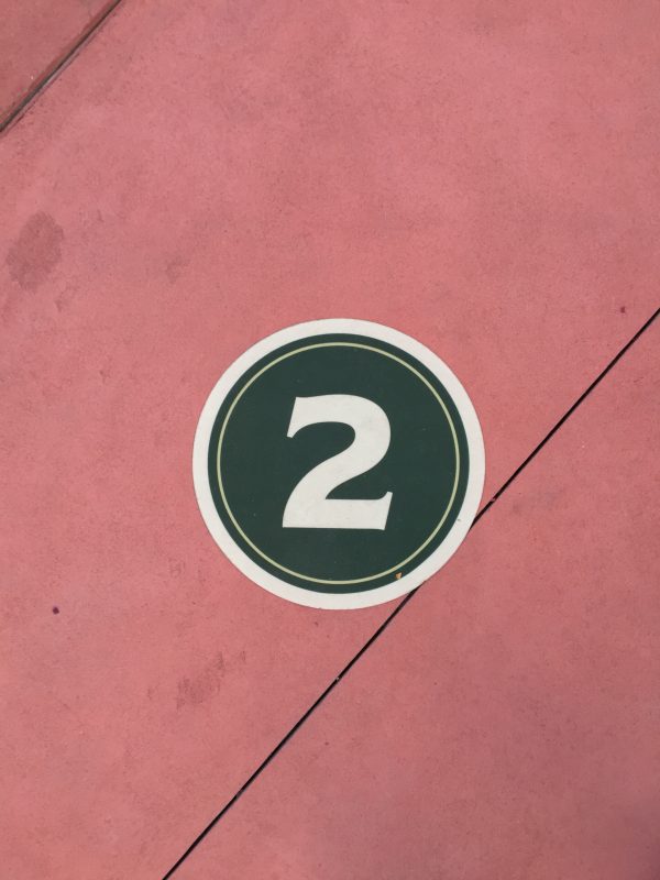 The number 2 is shown on a pink background