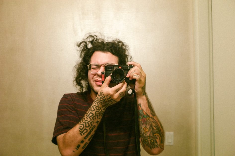 Person with tattoos taking a picture