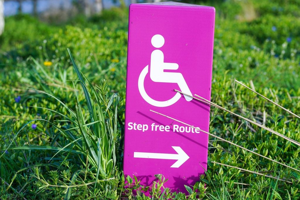 Sign in park showing the way to a step-free route for wheelchair access
