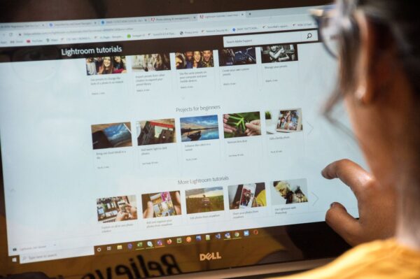 An over the should shot of someone selecting a tutorial from a menu on their computer.