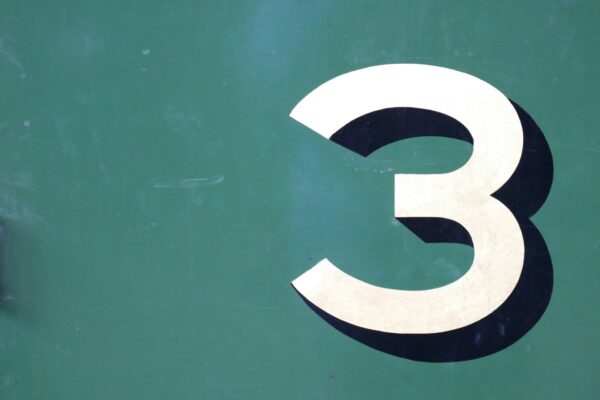 The number 3 on a green wall.