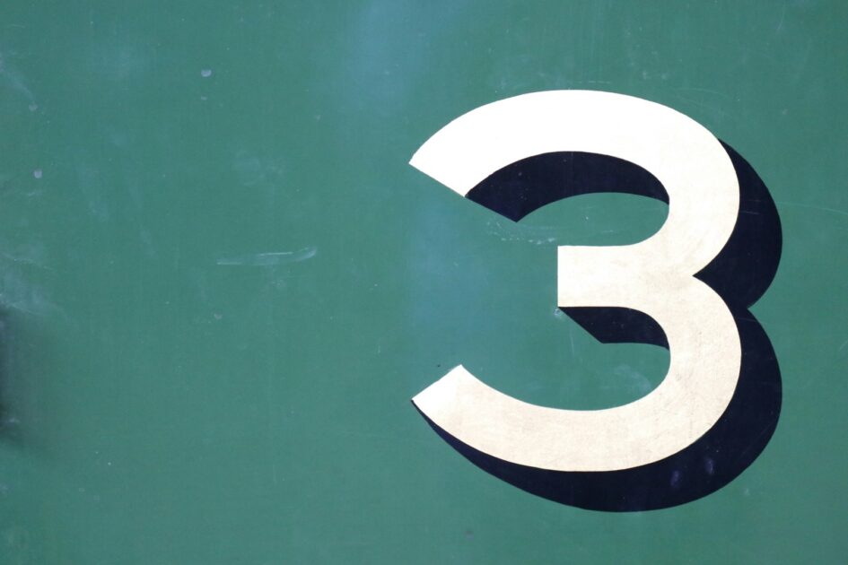 The number 3 on a green wall.