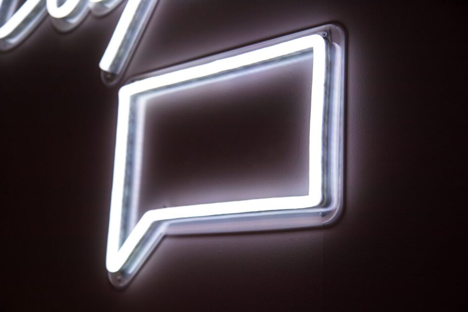 An neon sign in the shape of a comment icon