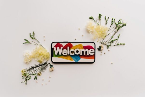 The word welcome set on a creative floral background.