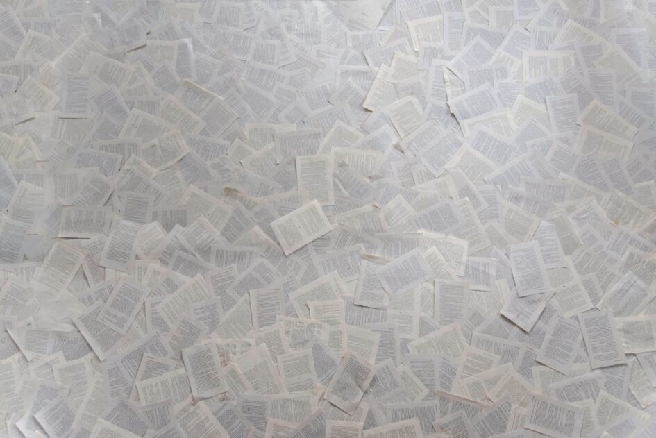 Many papers spread across a table.