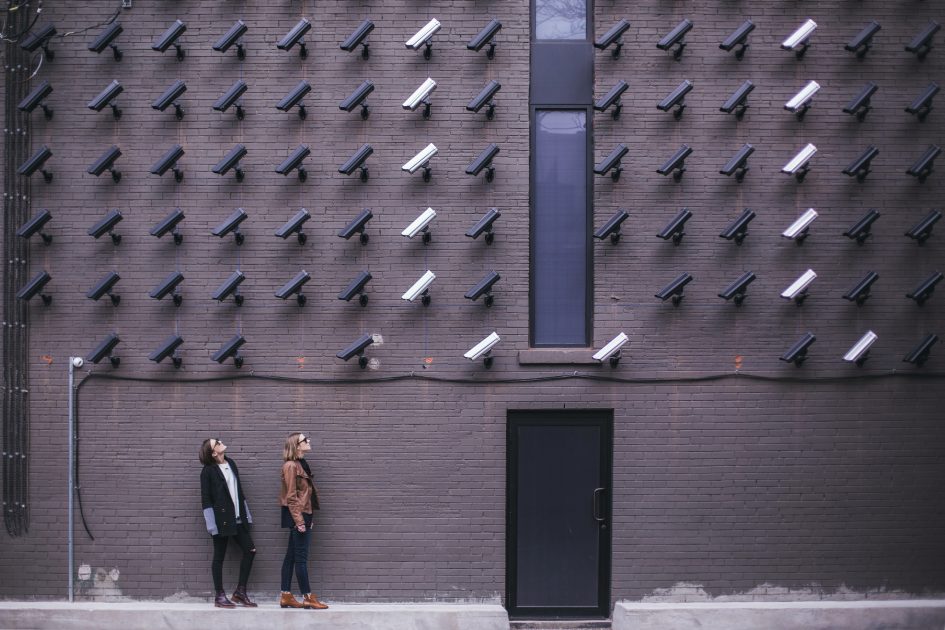 Cameras mounted on wall track 2 people