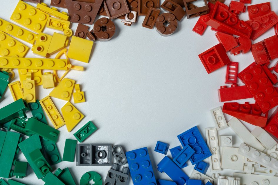 Lego pieces on a table sorted by colour