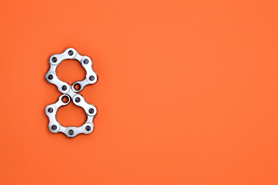 The number eight displayed in chain link on an orange background.