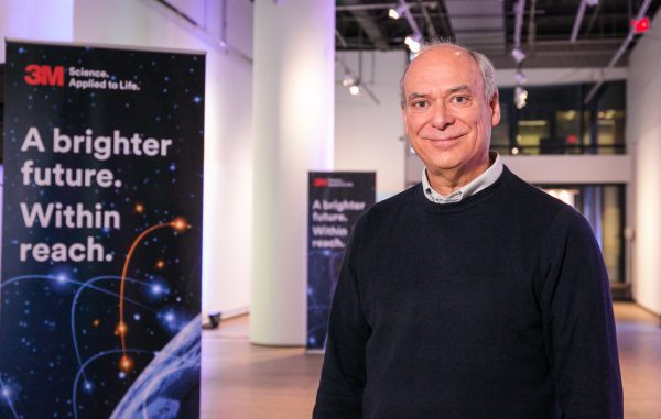 Photo of David Blades next to sign of 3M Science that reads, "A brighter future. Within reach."